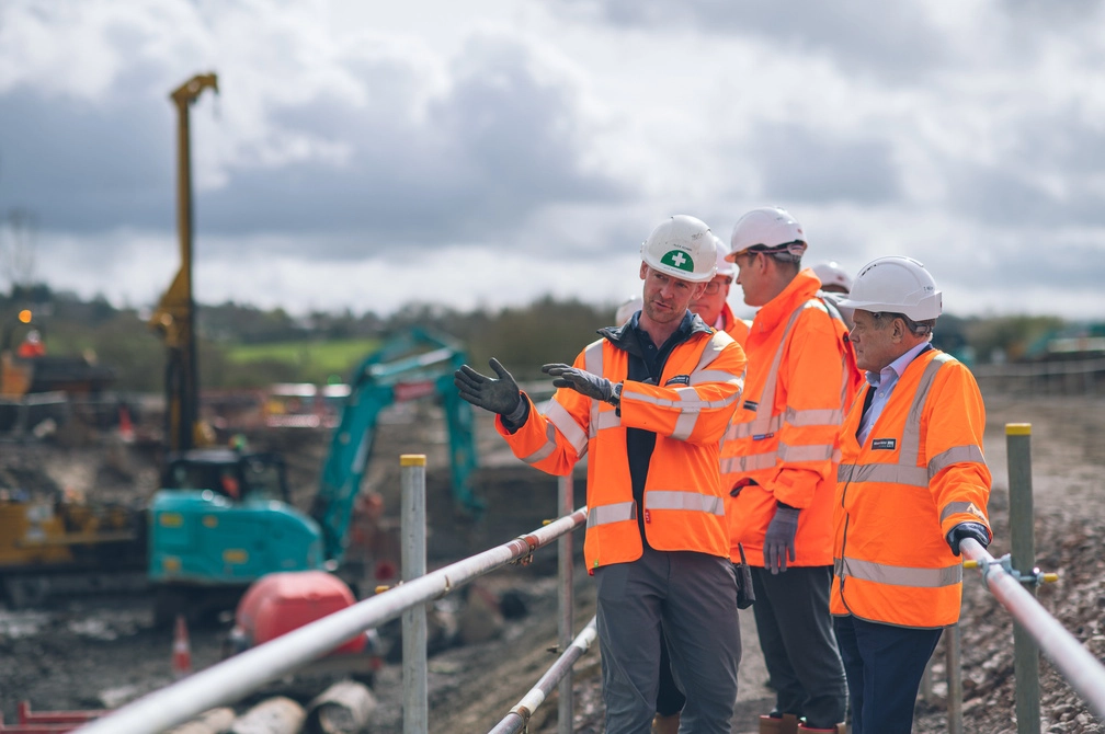 Group of Wessex Water employees in high vis and PPE walking around a construction site