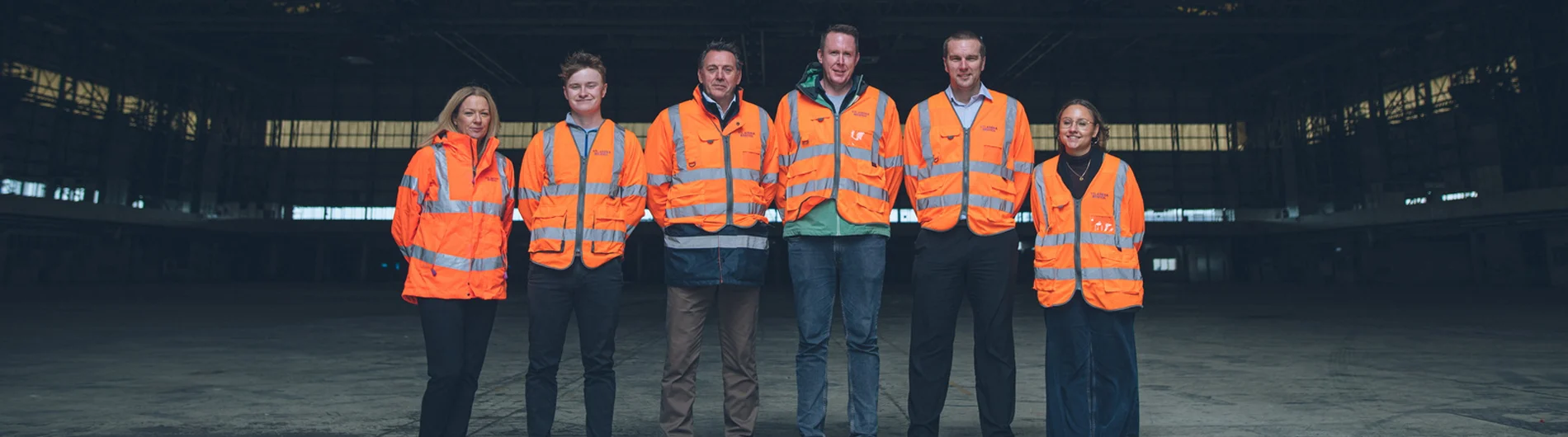A group of employees stood within the hangar